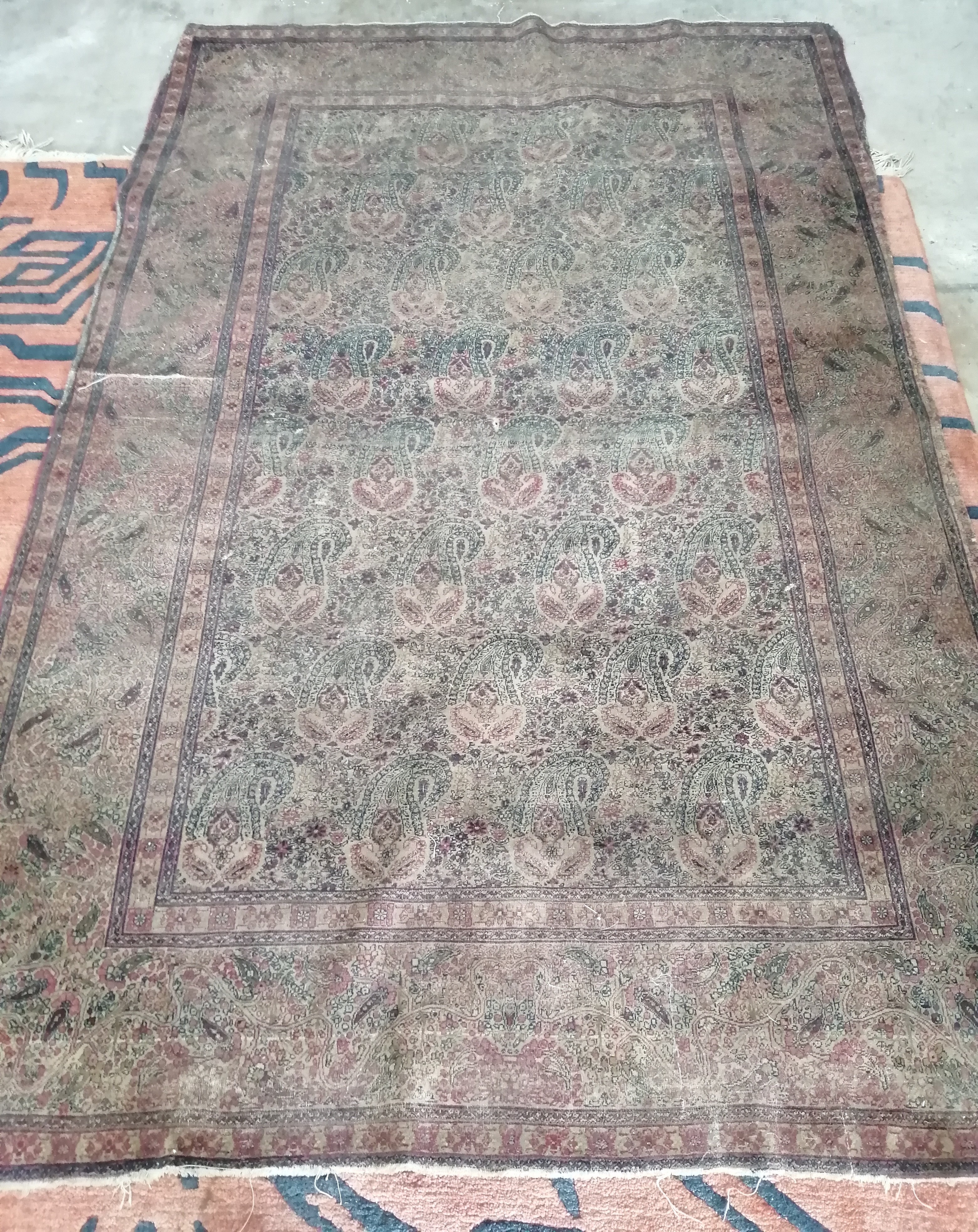 A Persian rug, woven with rows of botehs (worn), approx. 200 x 140cm